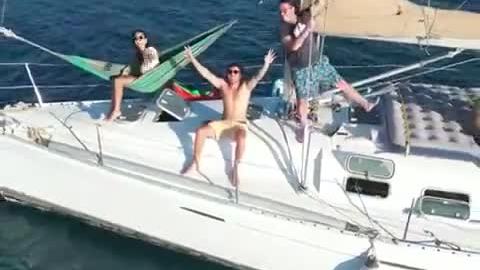 Travellers relaxing in hammocks on a sailboat in San Blas