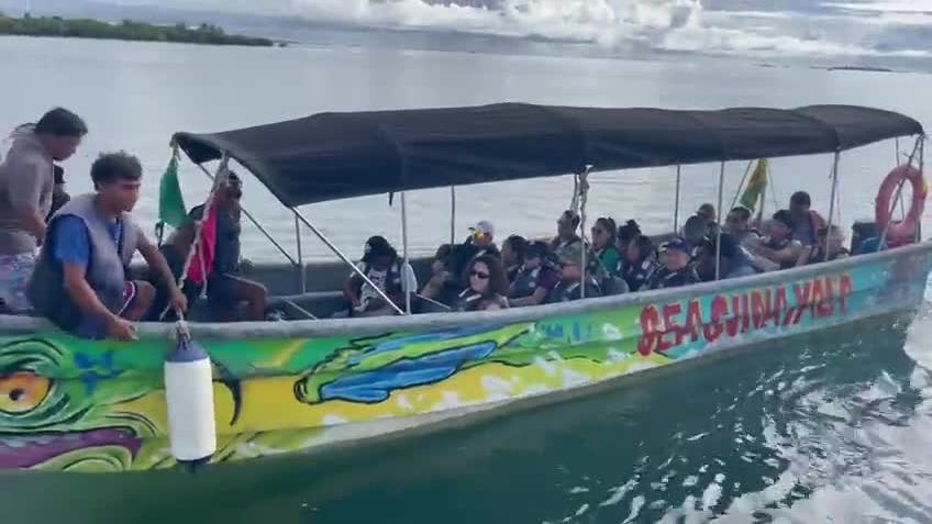 Travellers on a colourful lancha boat in San Blas