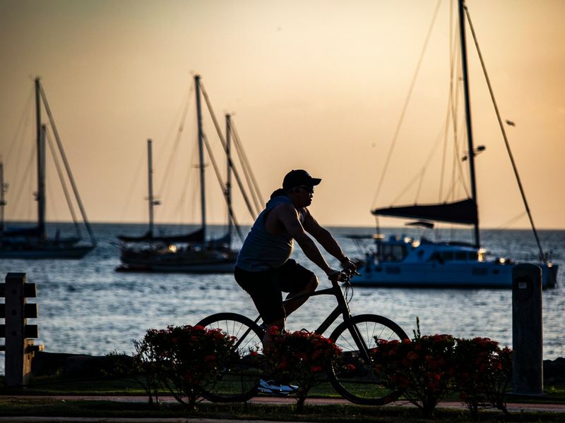 Cyclist riding by the sea with sailboats in Panama City