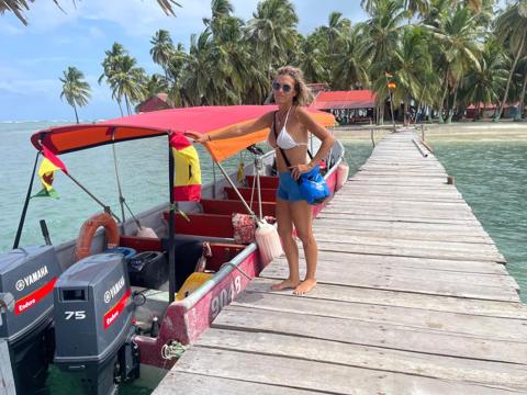 Guest on the pier next to a lancha in San Blas