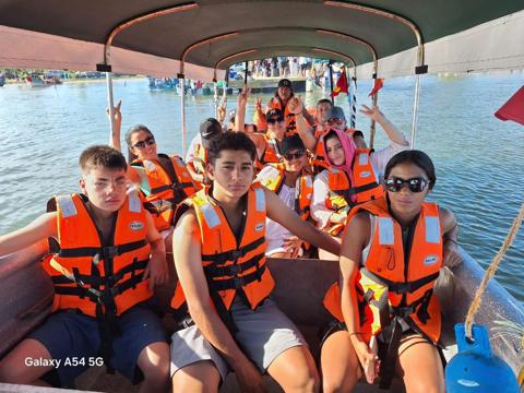 Group in life jackets on the boat