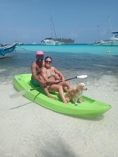 Couple and their dog on a green kayak
