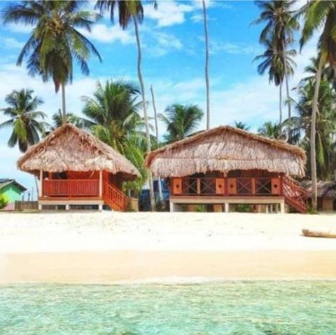 Thatched cabins on stilts facing the sea on Isla Seni